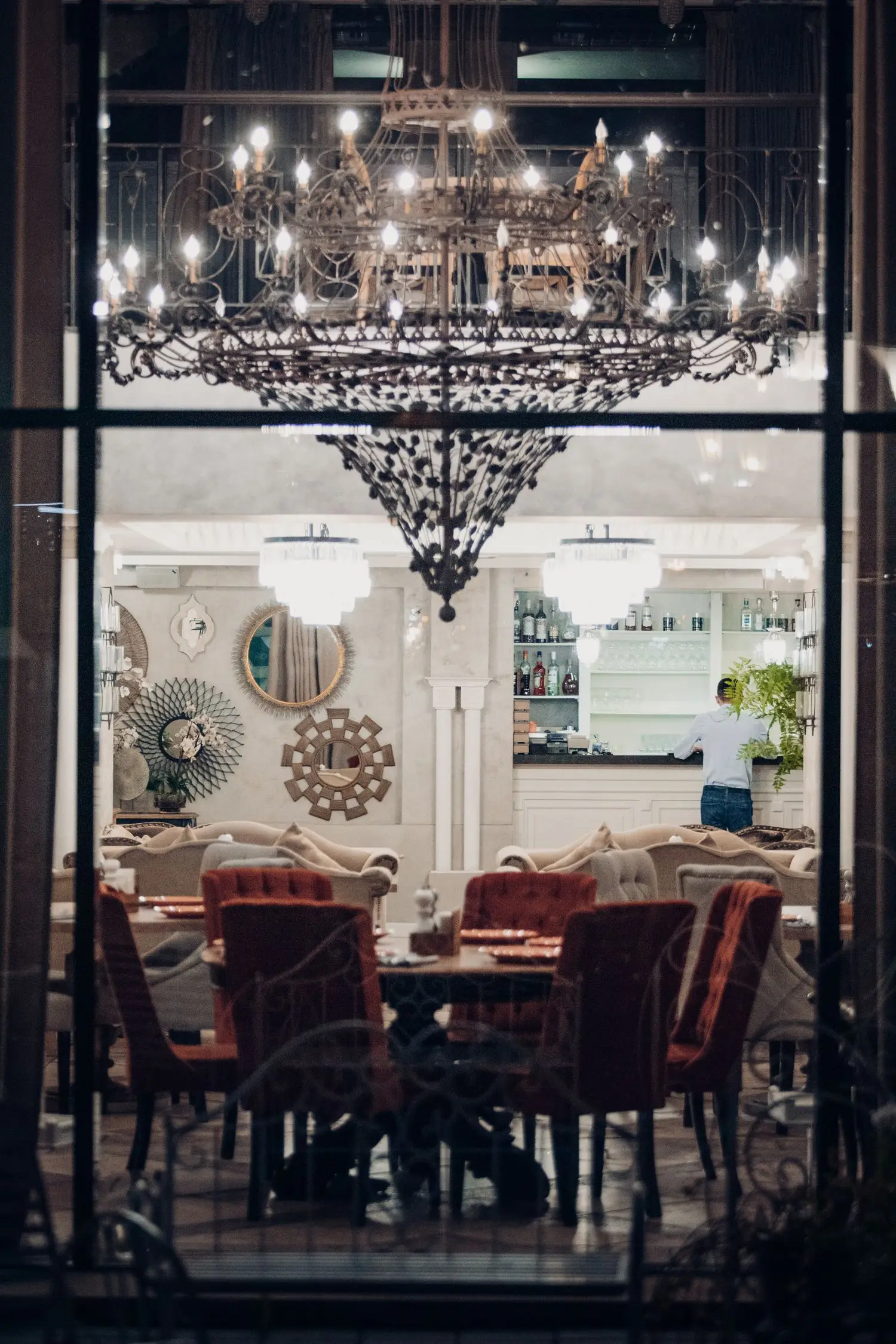 Restaurant dining room with chandelier and set tables