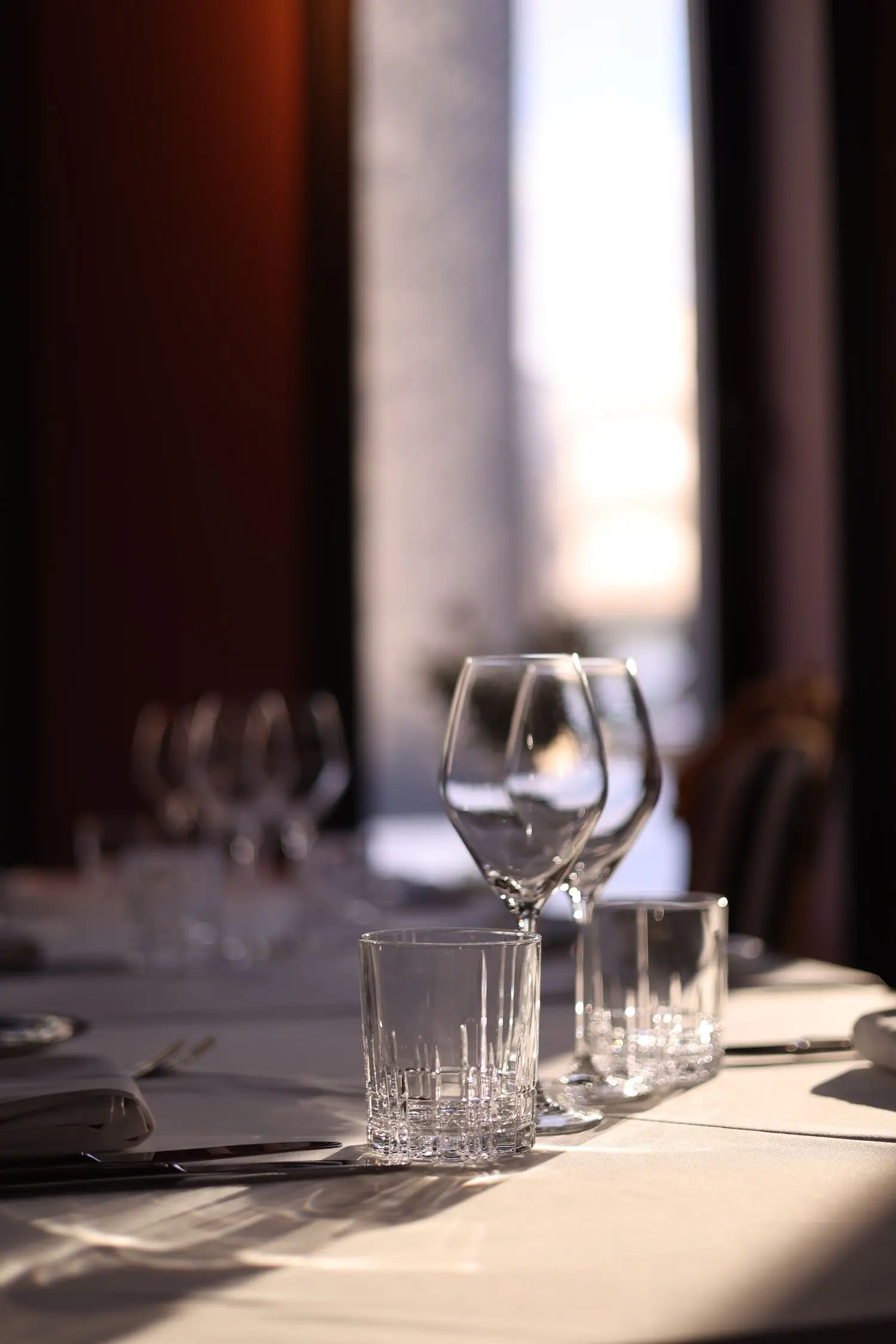 Minimal table setting beside a bright window