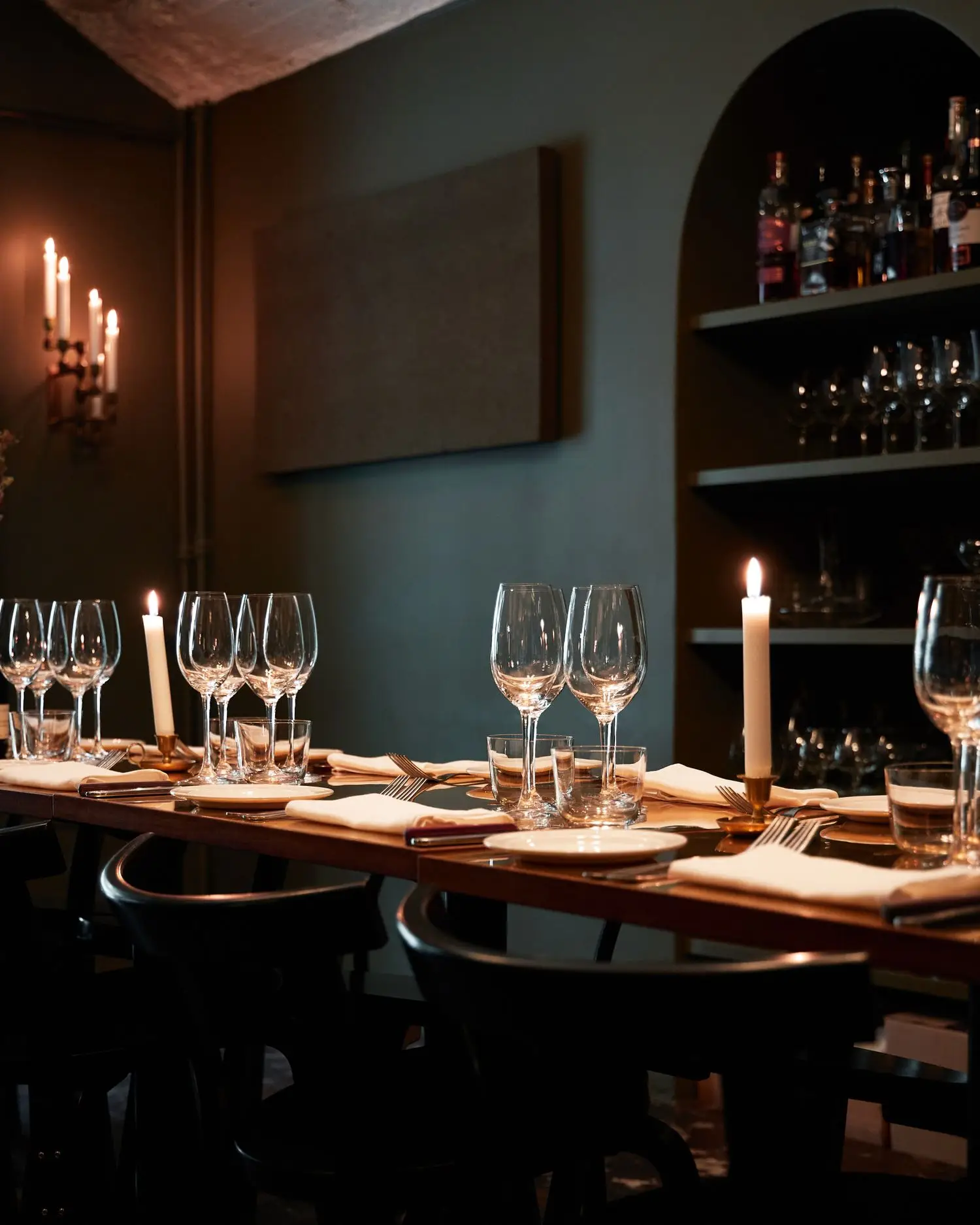 Dark dining table set for an intimate meal