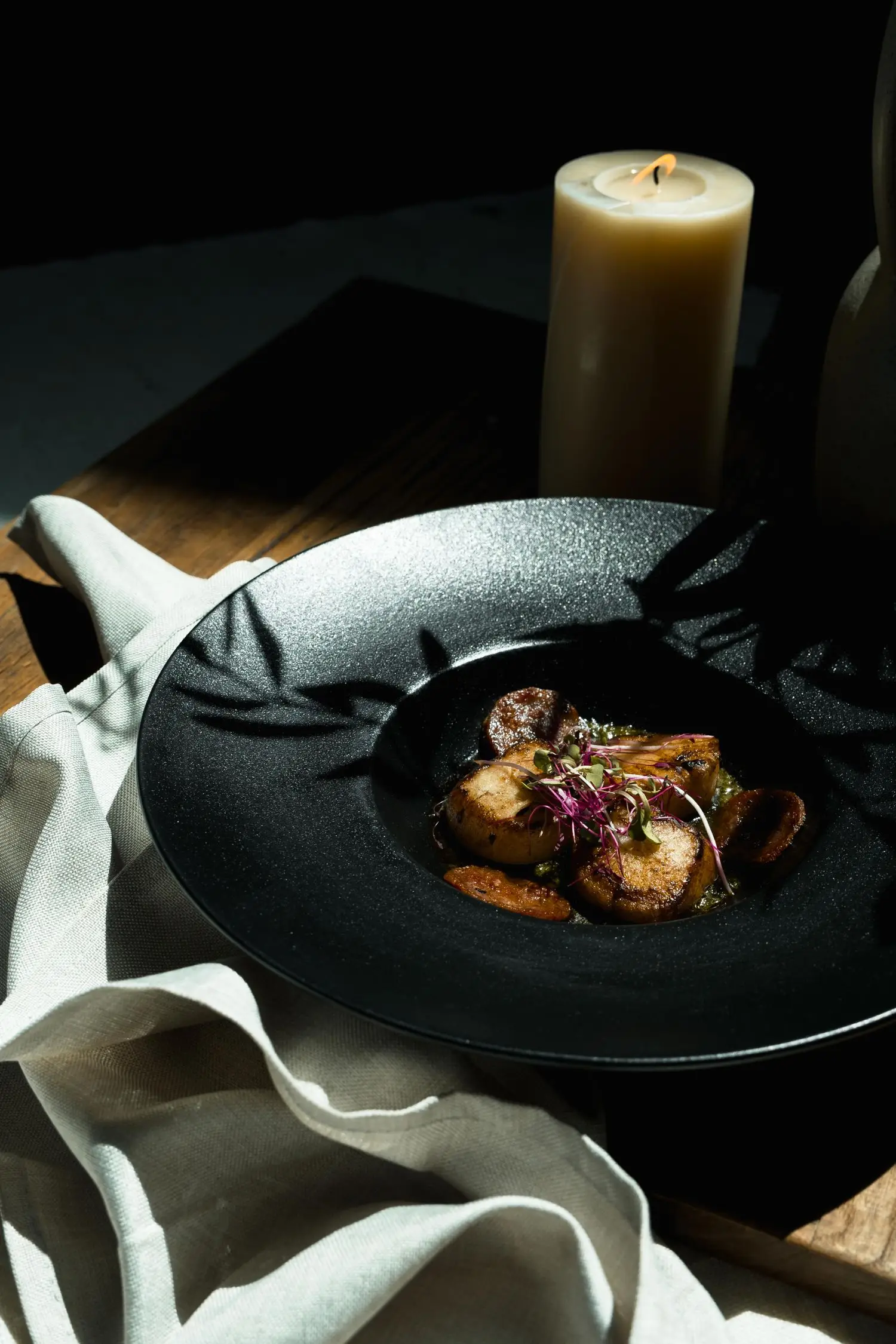 Plated seasonal dish beside a candle